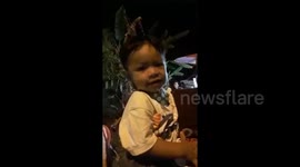 The boy is happy and dances when he hears the music.