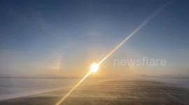 Vivid sun dog spotted shining over frozen Minnesota fields