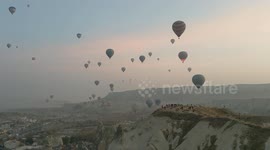 Hot air balloons flying over Cappadocia, Turkey at sunrise