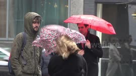 London shoppers struggle with umbrellas during Storm Dennis wind and rain