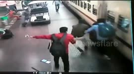Police officer saves woman falling from train at Indian railway station