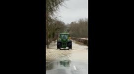 Tractor through floods after storm Dennis