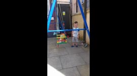 Toddler walks into swings frame, Nana laughs at him