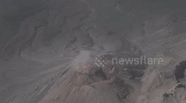Approching volcan santiaguito while letting out small plume of ash