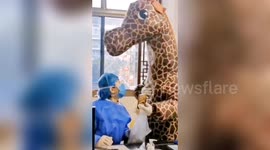 Chinese woman wears giraffe costume while visiting hospital amid coronavirus outbreak