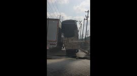 Overloaded truck sways dangerously along road