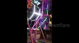 Husky rides ferris wheel, happily sitting in carriage
