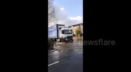 Vehicles drive through flooded streets in Stafford, UK