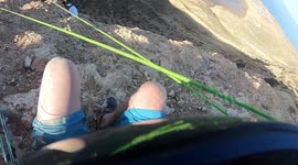 Paraglider comes inches from falling off '1,000ft' cliff face in failed launch