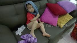 Funny toddler put his pants on his own head
