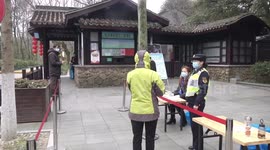 Tourists wearing masks visit China's West Lake on its first day of reopening
