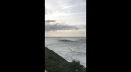 Surfers reach incredible speeds on monster waves during World Surf League Tow Surf Challenge at Nazaré, Portugal