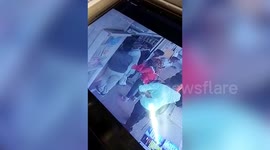 Watch the man in white - Indian pickpocket caught sneaking customers' mobile phones