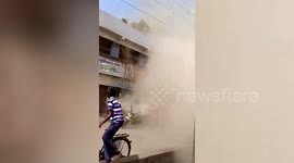 Terrifying footage shows moment two-storey building completely collapses next to busy Indian street