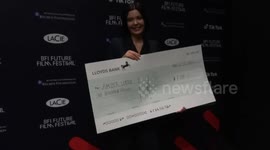 Young British film-maker Amber Little shows off her £1000 cheque award for the Best 19-25 Short Film at the 13th BFI Future Film Festival in London