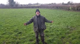 Happy Farmer dances in field Slips on mud and falls