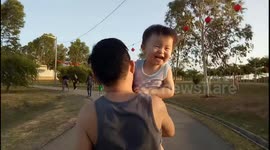 Toddler enjoys being hugged by his jogging dad