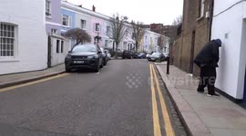 Man urinates in the street outside a house in Earls Court - London
