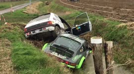Peugeot 205 crashes on top of Porsche at Rallye des Routes du Nord 2020
