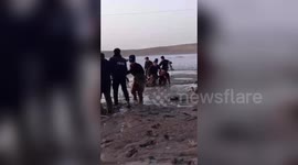 Police in northwest China rescue herdsman and his sheep trapped in wetland