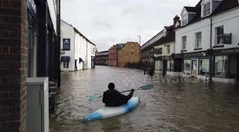 Kayaker seen on UK road as floods hit country