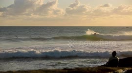 Surfing a point break at sunset in Morocco
