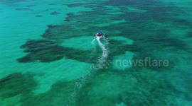 Boat cruising the Caribbean Sea off the coast of Cancun Mexico