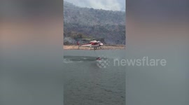 Helicopters dump water on forest fires in Thailand