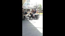 Thai teenagers caught riding without helmets are punished to sing by police