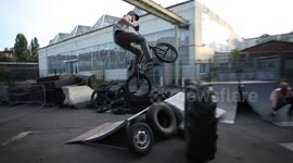 BMX Bike Rider jumps over Tractor Tire!