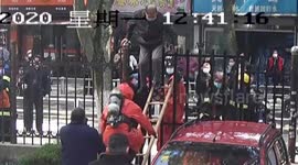 Chinese firefighters rescue man stuck on gate after attempting to climb over to enter community