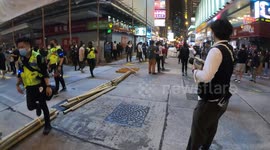 Hong Kong protesters bring bamboo sticks and other materials for barricades on Nathan Road