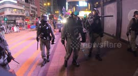 Hong Kong police fire tear gas as protesters return to streets despite coronavirus fears