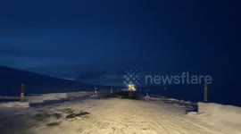A driver in northern Iceland drives behind the snow plow