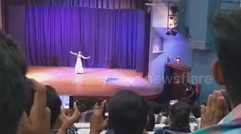 Belly dance performance in auditorium.