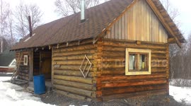 village russia. wooden house, spring, snow, icicles