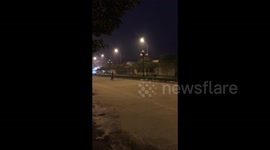 Locals play badminton on a public road in Vietnam.