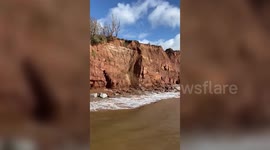 Large section of cliff collapses onto popular beach in Devon, UK