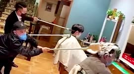 Hairdressers in China attach tools to sticks to keep safe distance from customers amid COVID-19 outbreak