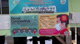 Travellers seen wearing masks as first coronavirus cases confirmed in Indonesia