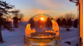 Icy conditions cause a water ball to instantly freeze in a mesmerising pattern