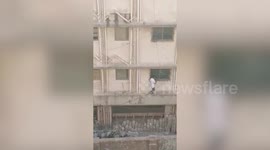 Criminal suspect seen escaping from police building out toilet window in west India