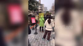 Chinese residents line up to buy face masks from self-service machine