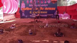 Indian farmers plant themselves neck-deep in soil to protest government land seizure