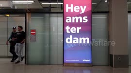 Man with face mask due to Corona virus outbreak walks by on Schiphol Airport (NL)