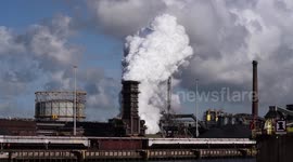 Huge clouds emerging from chimney in industrial area