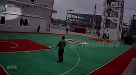 Chinese firefighter volleys basketball into hoop from outside the court