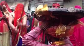 LATHMAR HOLI: Hundreds of women gather with sticks to beat up men hiding under cushion in Northern India