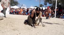 Daring woman places her head in alligator's jaws during wrestling competition in Florida