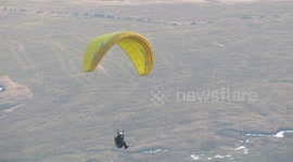 Daredevils paragliders soar over England's Peak District in freezing temperatures